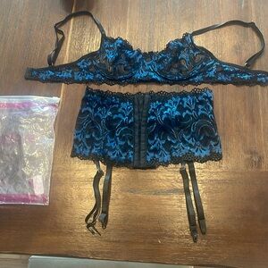 Brand new! Size small lace bra and garter. Blue and black